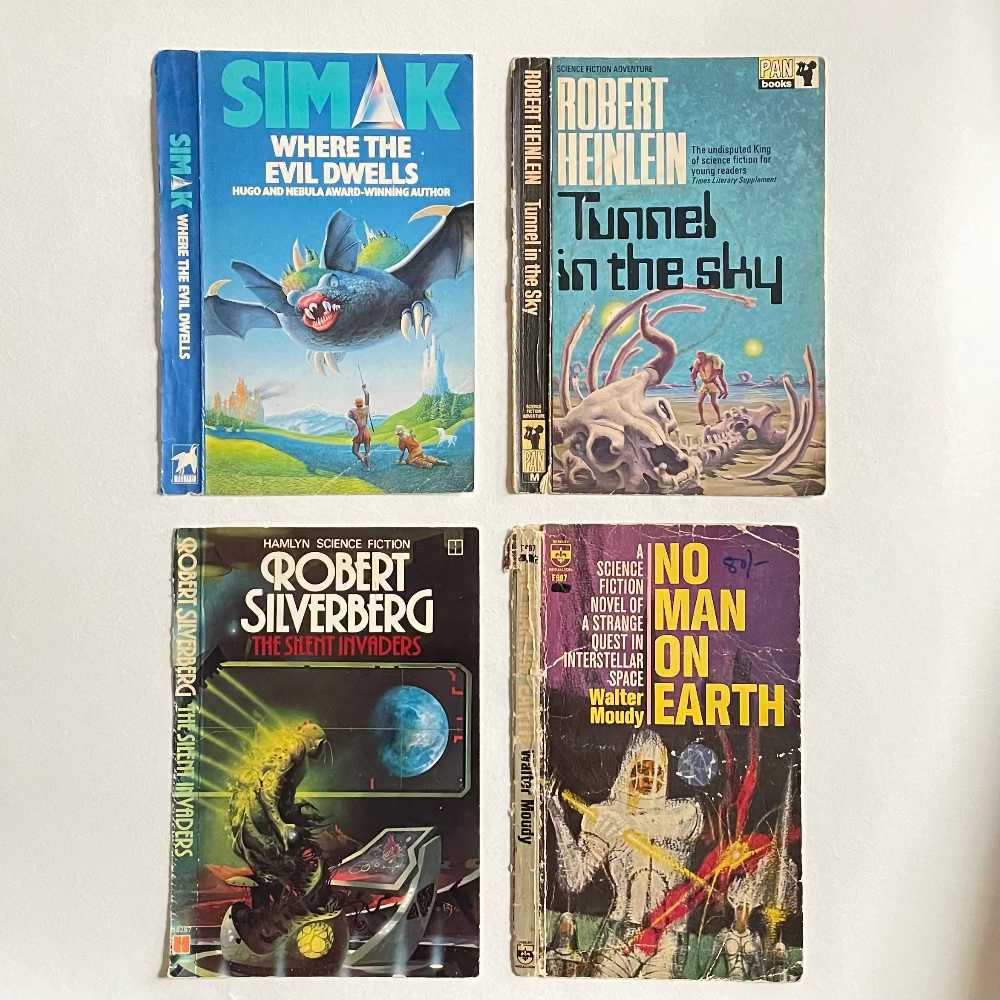 Four vintage science fiction books on a white background