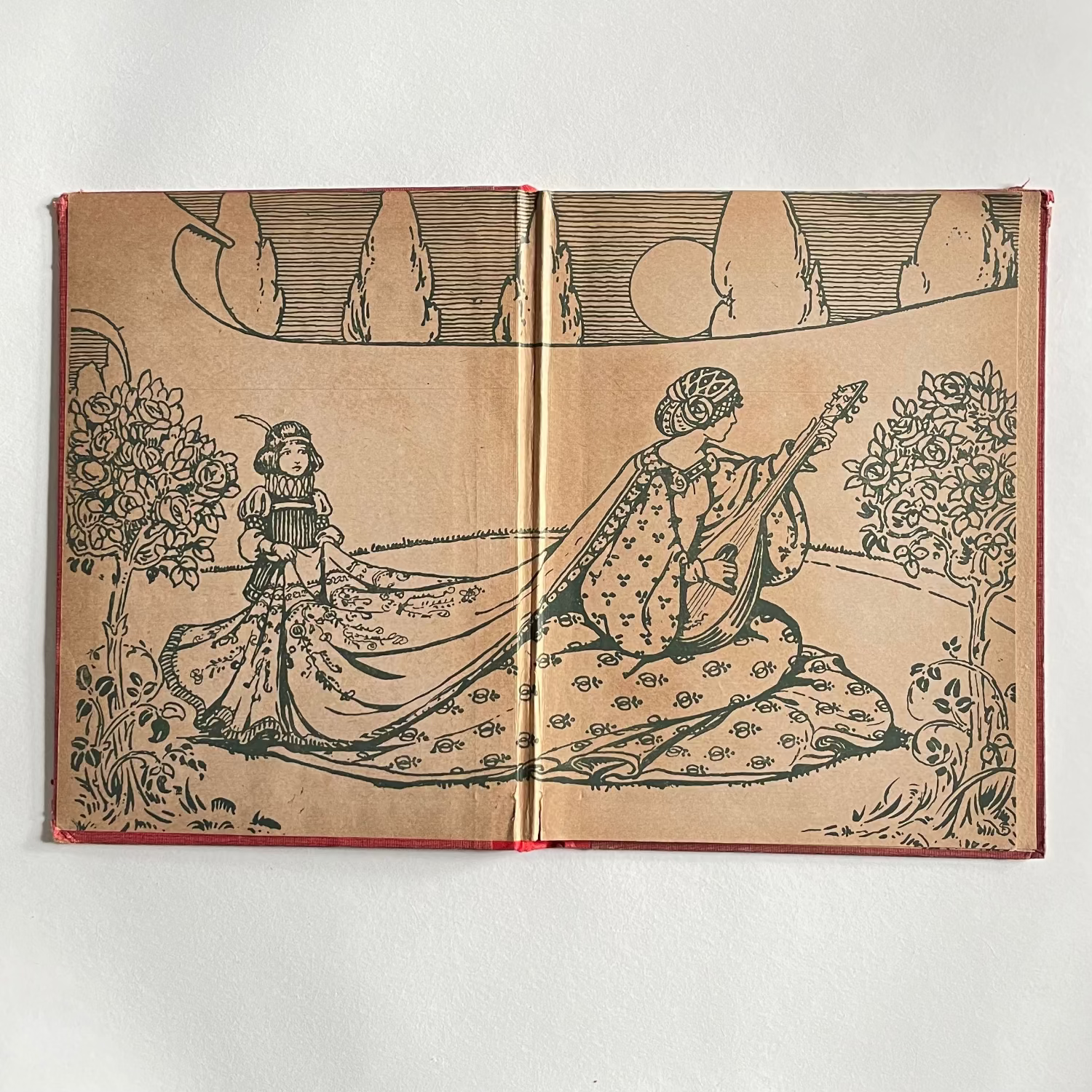 Open book with illustrations of two figures in a garden setting on a white background
