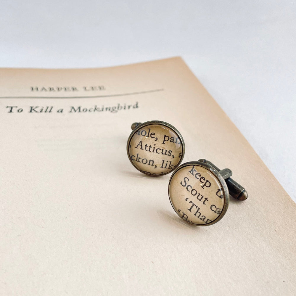 Cufflinks with text on an open book titled 'To Kill a Mockingbird' by Harper Lee.