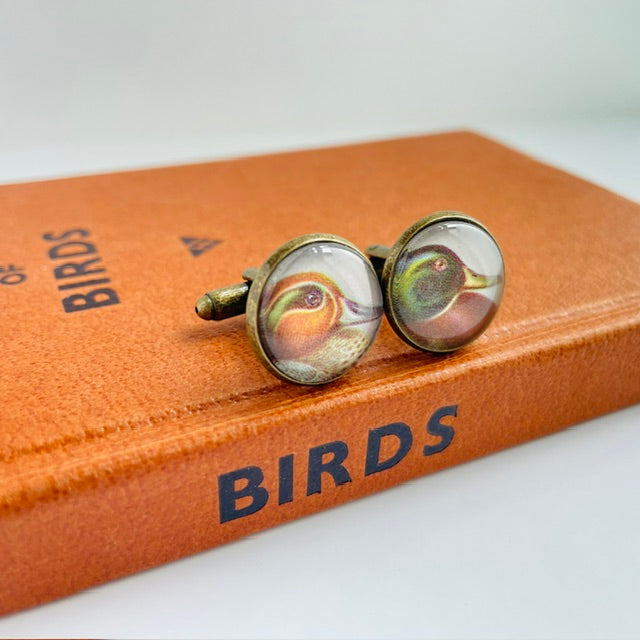 Bronze round cufflinks with an illustration of a duck, taken from a bird identification book
