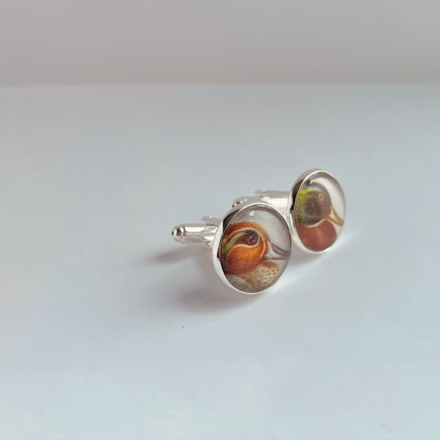 silver plated round cufflinks with an illustration of a duck, taken from a bird identification book