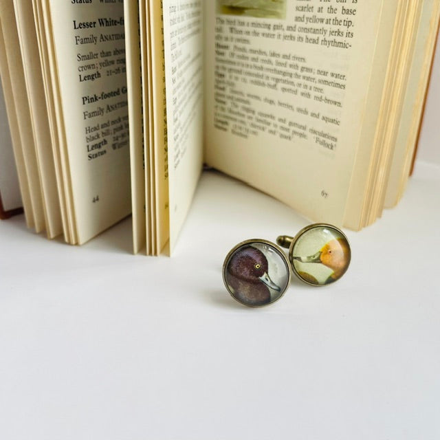 Bronze round cufflinks with an illustration of a duck, taken from a bird identification book