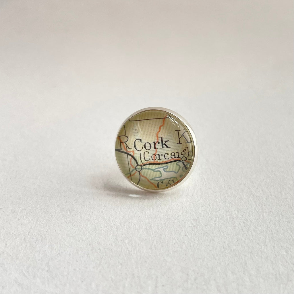 Map-themed pin with 'Cork' on a light gray background
