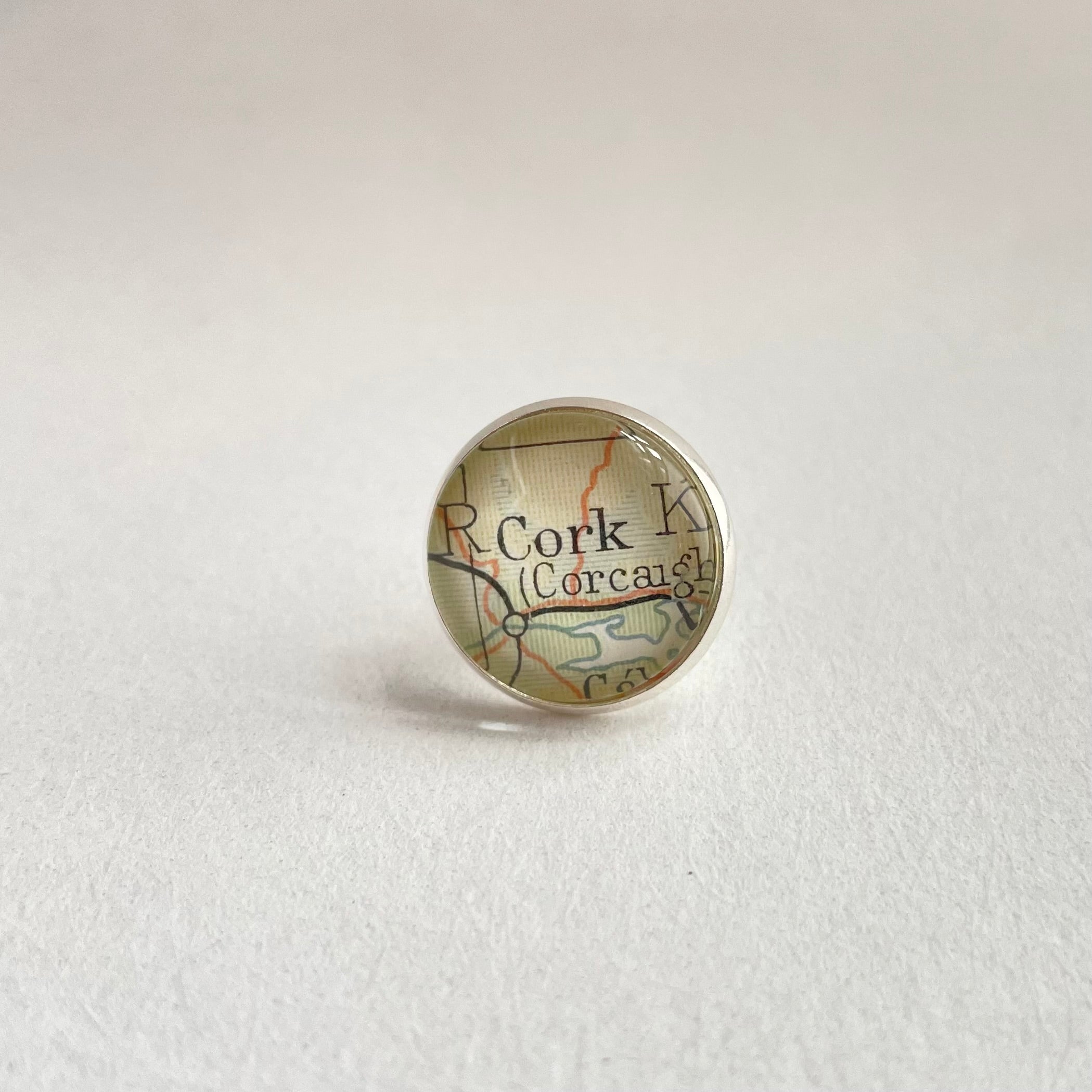 Map-themed pin with 'Cork' on a light gray background