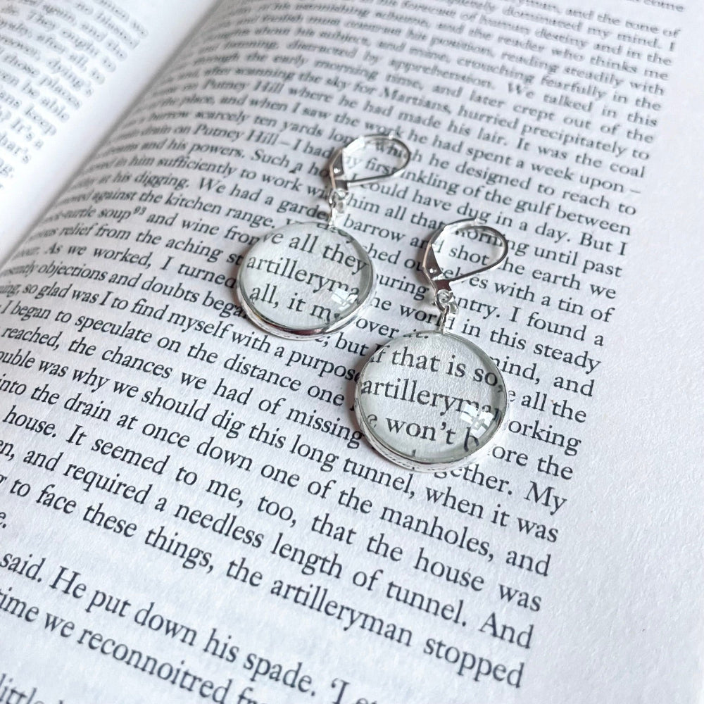 a pair of round dangle book earrings showing the silver variation
