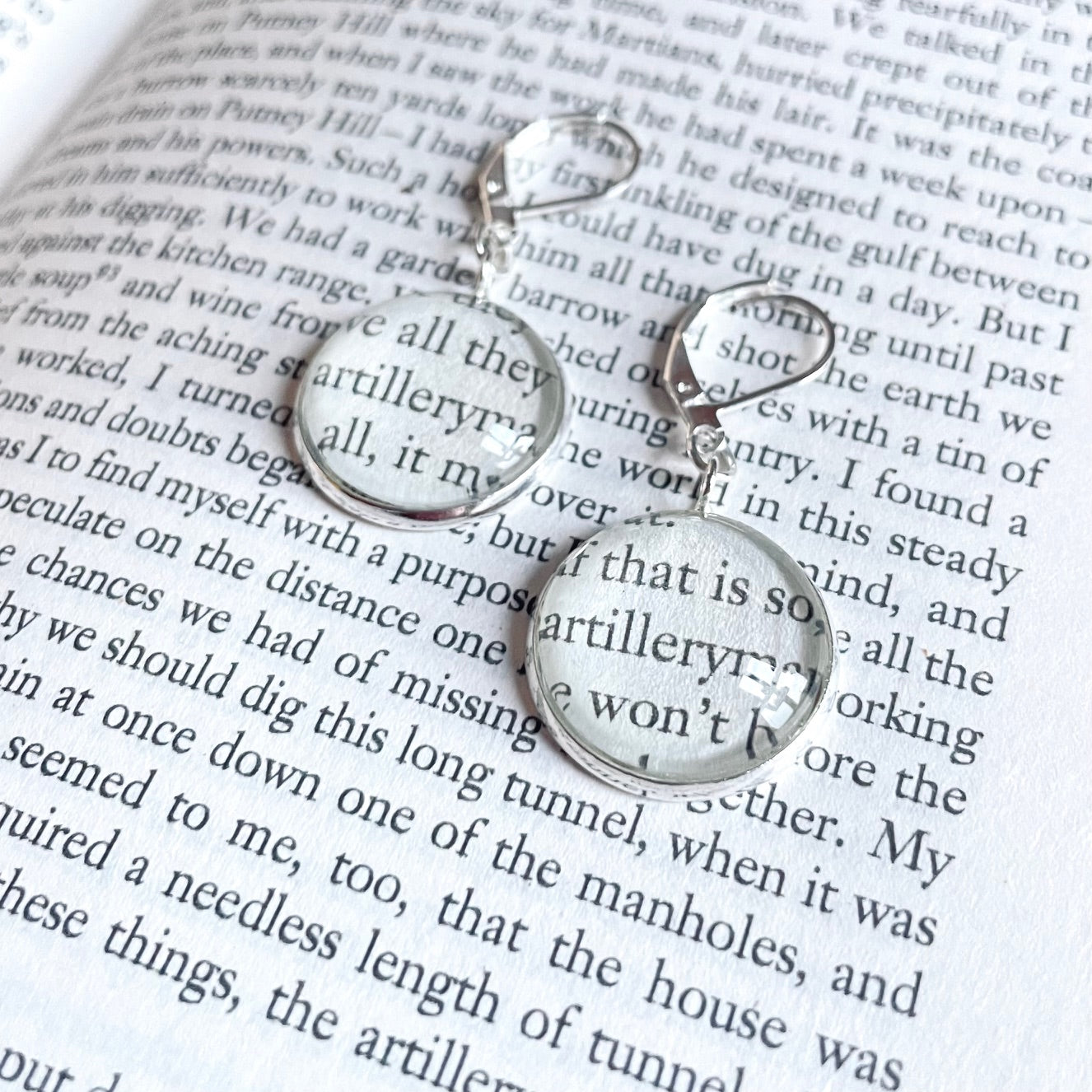 Silver round earring made from war of the worlds book pages