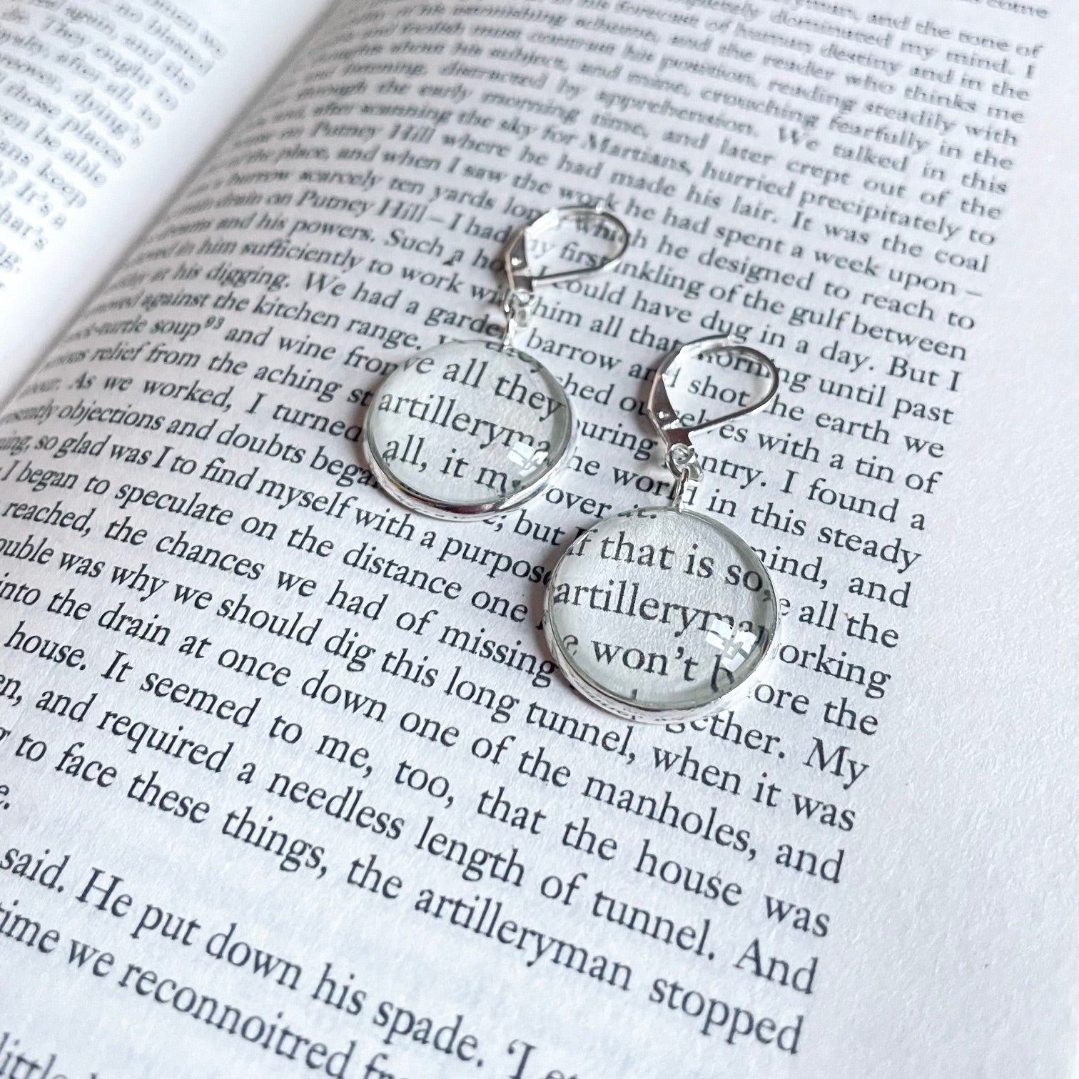 Silver round earring made from war of the worlds book pages