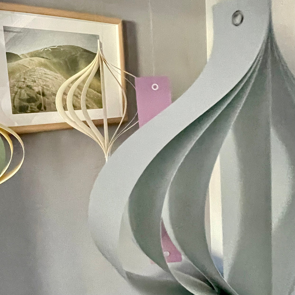 Pastel home ornaments in dusty pastel tones of green, yellow, beige, blue and purple on a neutral background