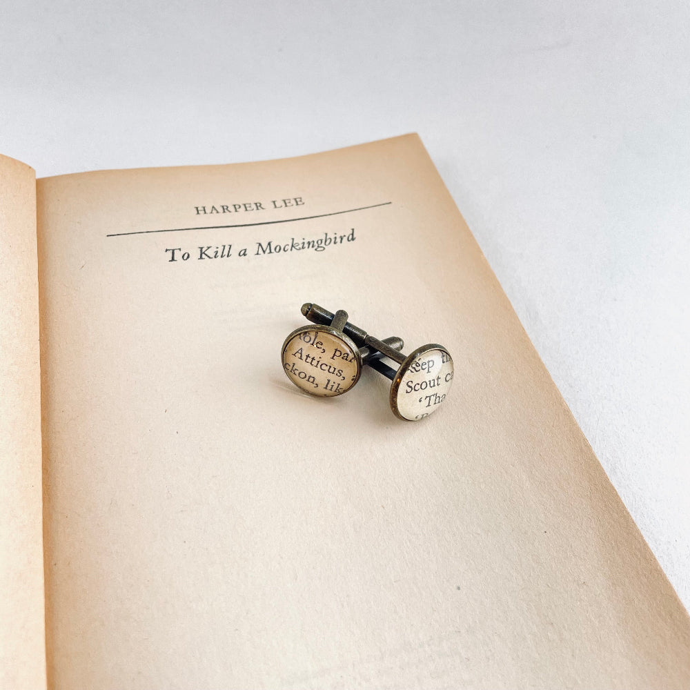 Cufflinks with text on an open book titled 'To Kill a Mockingbird' by Harper Lee.