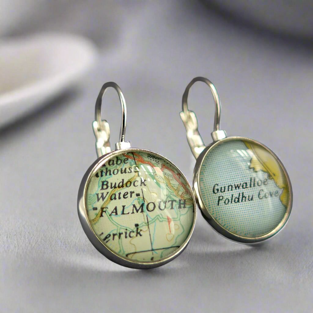 Round silver earrings featueing a section of real map sealed under glass